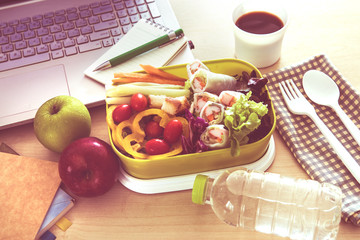 Close up green Lunch box on the work place of working desk ,Healthy eating clean food habits for diet and health care concept