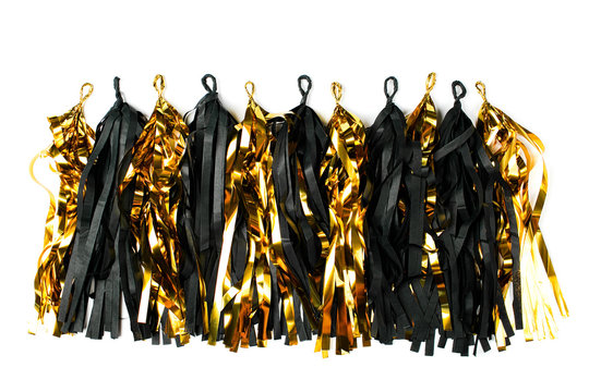 Black and gold fringe tassel garland background. Holiday concept