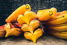 Stacked Kayaks On A Beach