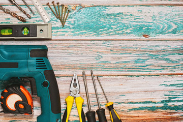 Variety of hand tools and machines on rough table