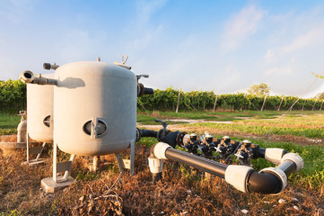 Irrigation water pumping system with tanks in vineyard.