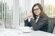© somchaikhun - Modern asian business woman working in office with copy space and sun rise.