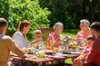 © Syda Productions - happy family having dinner or summer garden party
