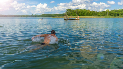 Wall Mural - Man swimming in a lake