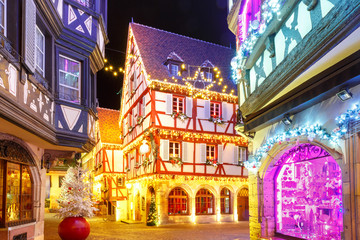 Wall Mural - Traditional Alsatian half-timbered houses in old town of Colmar, decorated and illuminated at christmas time, Alsace, France