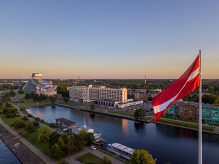 Beautiful aerial sunset view over AB dam in Riga Latvia with a huge Latvian flag