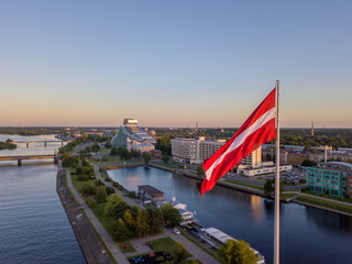 Beautiful aerial sunset view over AB dam in Riga Latvia with a huge Latvian flag