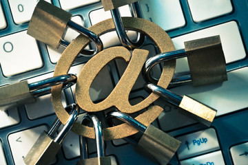 Wall Mural - Email sign with many padlocks on computer keyboard / Email encryption security and countermeasure concept
