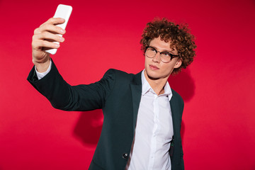 Poster - Confident stylish man in eyeglasses taking selfie