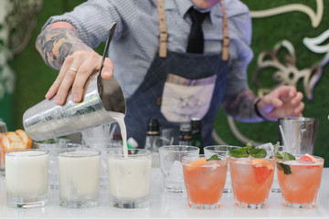 Bartender pouring drinks at party