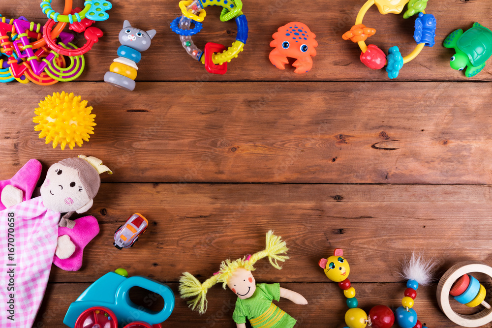 group of baby toys on wooden background with copy space. top view - obrazy, fototapety, plakaty 