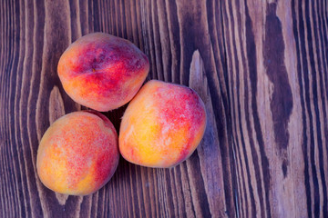 Sticker - Juicy peaches on wooden background