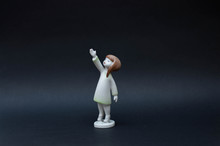 Porcelain Girl Figurine Isolated On Black Background