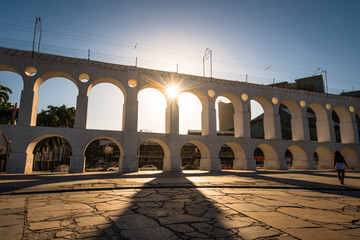 Wall Mural - Sun Shines Through Landmark Lapa Arch in Rio de Janeiro City Downtown