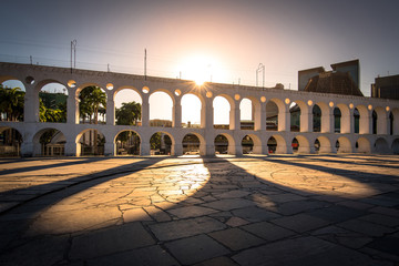 Fototapete - Sun Shines Through Landmark Lapa Arch in Rio de Janeiro City Downtown