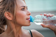 © igorp17 - healthy lifestyle young woman runner drinking water while doing her exercise