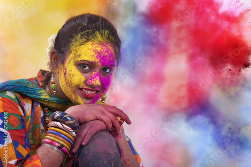 Portrait of young Indian Woman celebrating Holi color festival Poster