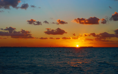 Wall Mural - Colorful sky at Beach / Romantic sunset on Isla Mujeres in Mexico 