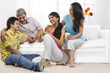 © IndiaPix - Family sitting together in the living room