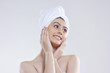 © IndiaPix - Beautiful woman with hair wrapped in towel looking away against white background