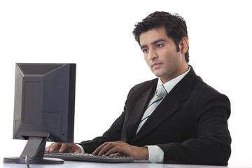 Young businessman using computer at desk 