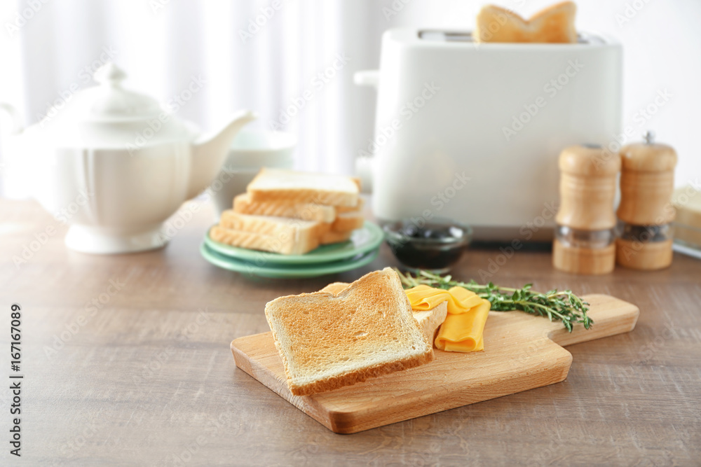 Wooden board with tasty breakfast toasts on table