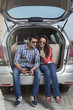 © IndiaPix - Young man and young woman sitting in the trunk of a car