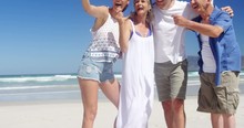 Happy Family Taking Selfie From Mobile Phone At Beach