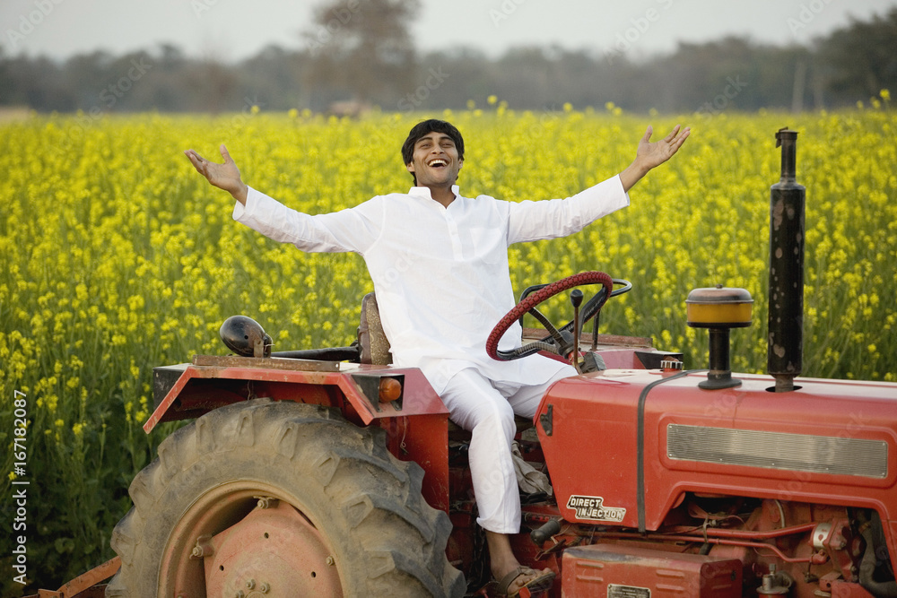 A farmer on his tractor Stock Photo | Adobe Stock