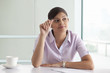 © IndiaPix - Businesswoman thinking while preparing new project