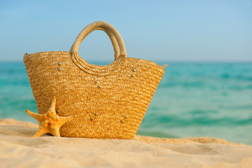 Wall Mural - Summer mood, straw bag on the background of the sea.