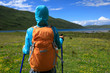 young backpacking woman hiking in the nature