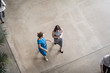 © ReeldealHD images - Overhead shot of a two businesswomen walking through an office