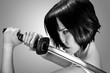 Anime stylized brunettewith short hair watching with stern look holding a katana sword with two hands