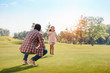 © LIGHTFIELD STUDIOS - happy african american granddaughter running to grandfather on green lawn in park