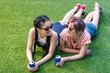 © LIGHTFIELD STUDIOS - beautiful multiethnic girls in sunglasses holding soda cans and smiling each other while lying on green grass