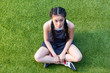 © LIGHTFIELD STUDIOS - high angle view of beautiful young asian woman looking at camera while sitting on grass