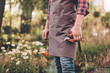 © LIGHTFIELD STUDIOS - selective focus of gardener in apron holding pruning shears in hand