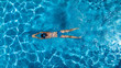 © Iuliia Sokolovska - Aerial top view of woman in swimming pool water from above, tropical vacation holaday concept