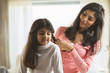 © IndiaPix - Mother styling hair of daughter