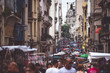 The narrow street of Buenos Aires is crowded with people. Shevelev.