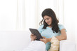 © IndiaPix - Woman reading an article on a digital tablet