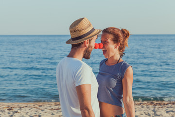 Wall Mural - Funny young couple in love on the beach