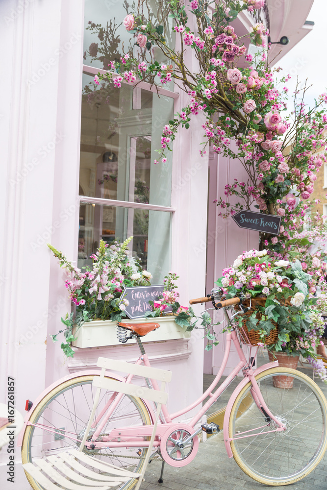 Photography of pink bicycle near restaurant with amazing interior - obrazy, fototapety, plakaty 