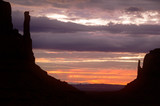 Fototapeta  - Colorful sunrise landscape in Monument valley with silhouette of buttes