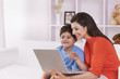 © IndiaPix - Mother and son looking at laptop
