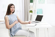 © Africa Studio - Beautiful young pregnant woman working at home