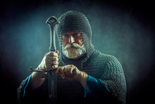 Powerful Bearded Knight With The Sword On The Dark Background
