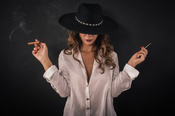 Wall Mural - Portrait of sexy elegant lady woman with hat smoking cigar