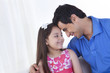 © IndiaPix - Happy father and daughter with head to head at home